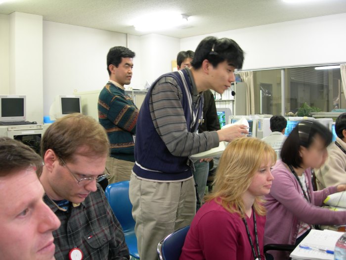 Men and women from NASA and ISAS keep their eyes on the telemetry data, filling the depth of focus. (70K JPEG)