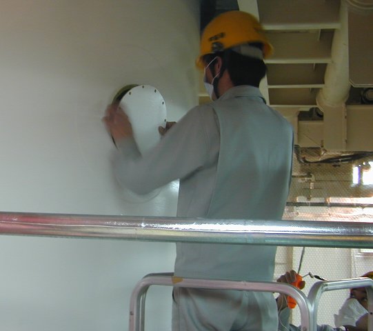 Small cover being placed over the hole (34K JPEG)