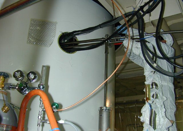 Wires and tubes poking into a hole in the nose fairing. (66K JPEG)