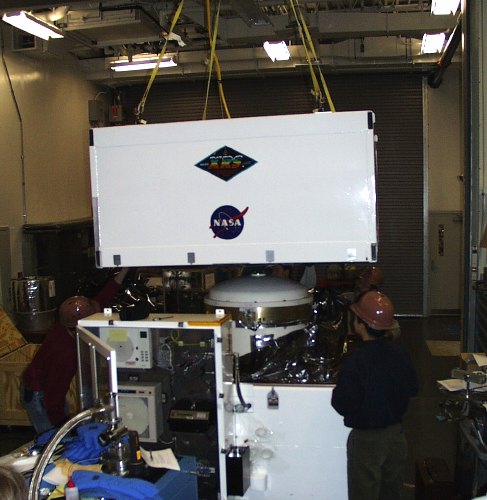 The lid being lowered onto a big white box (54K JPEG)