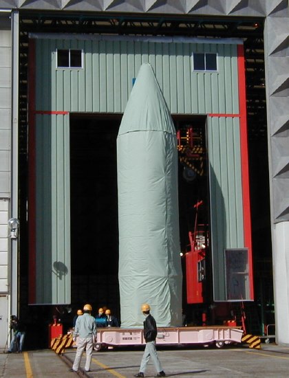 ASTRO-E coming through a large door to the outside (52K JPEG)